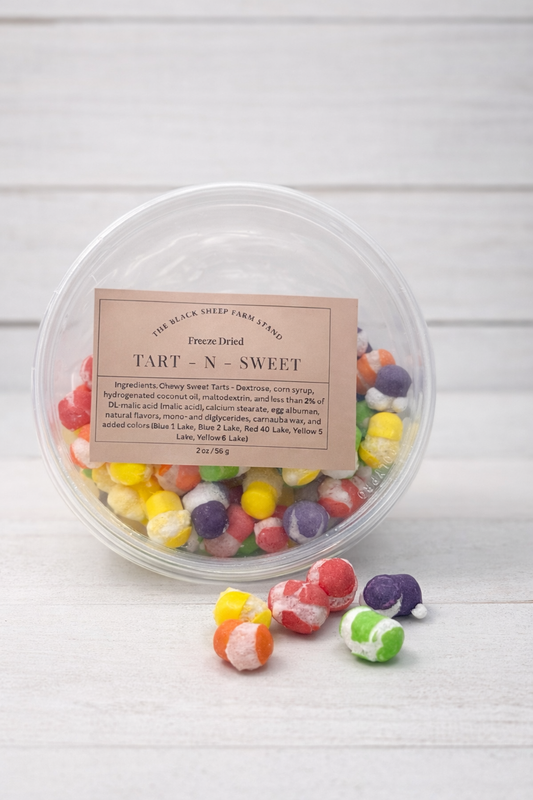 Container of colorful gummy candies with a label on a white background