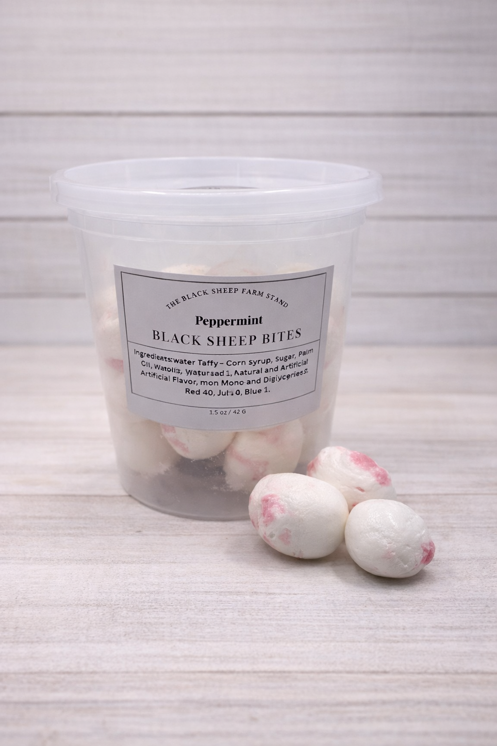 Container of peppermint black sheep bites on a textured surface