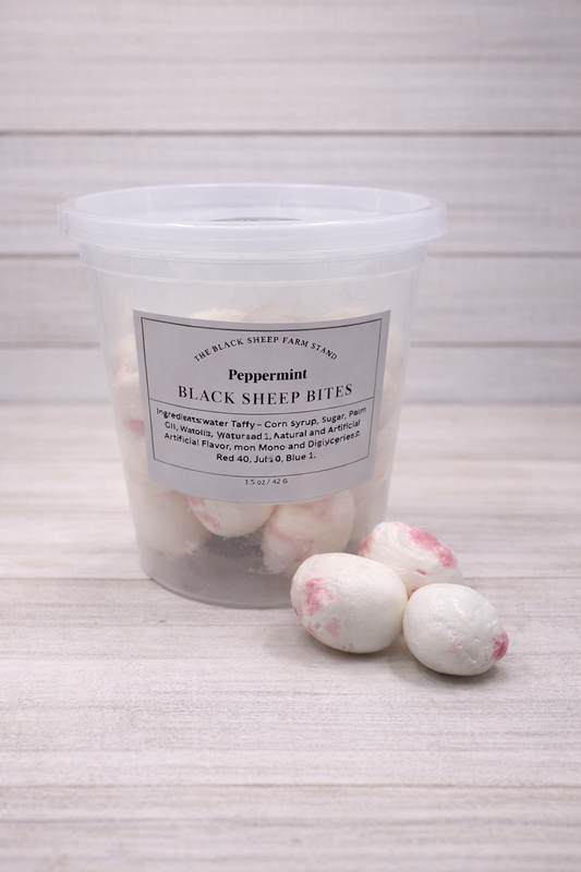 Container of peppermint black sheep bites on a textured surface