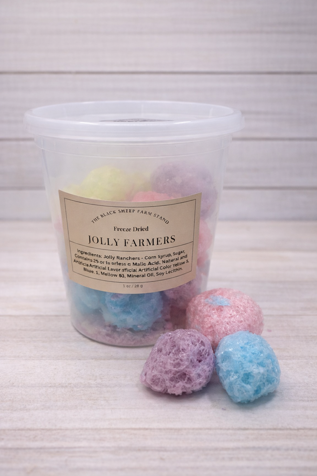 Jar of colorful bath bombs with a label on a white background