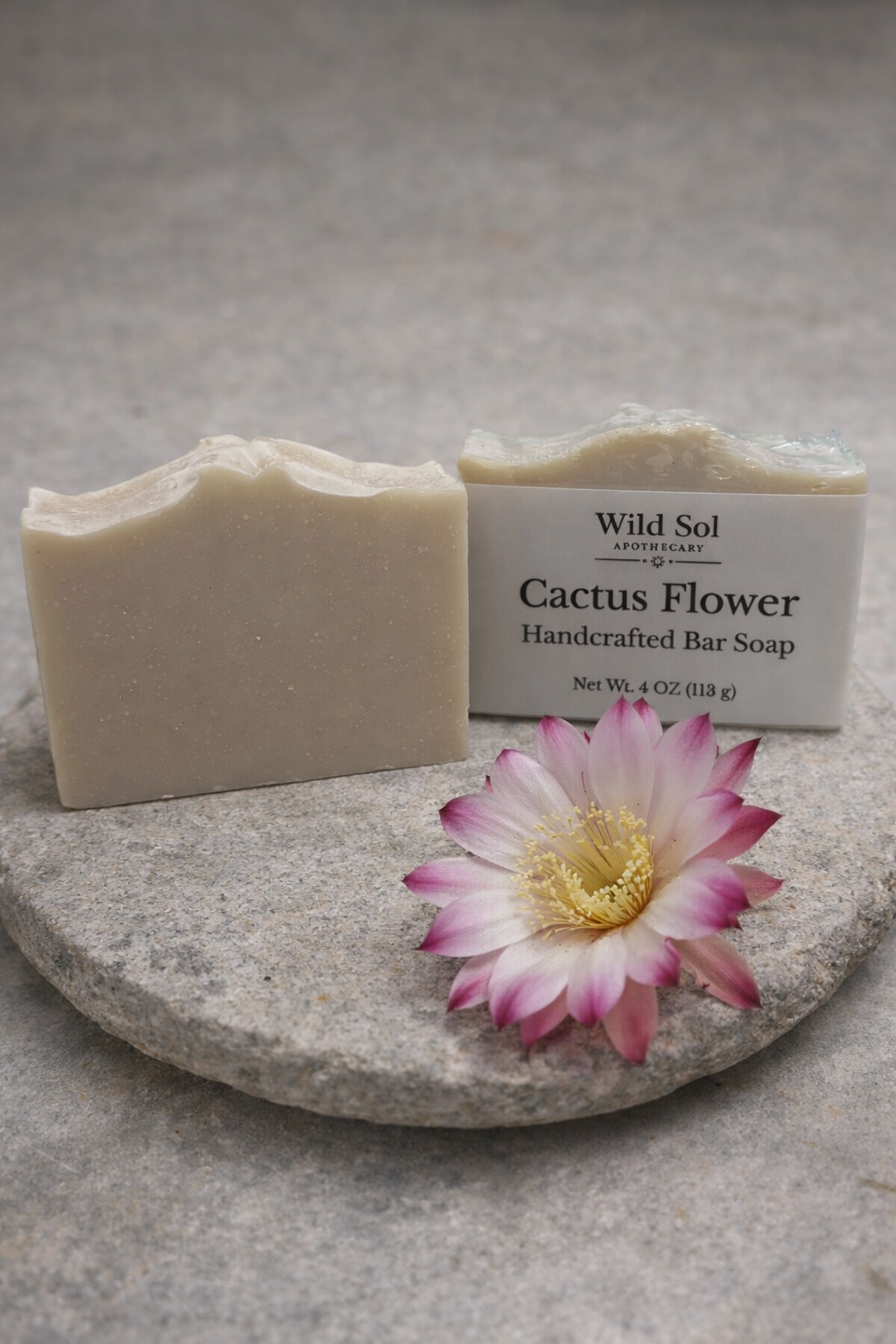 Handcrafted Cactus Flower soap bar with a pink flower on a stone surface