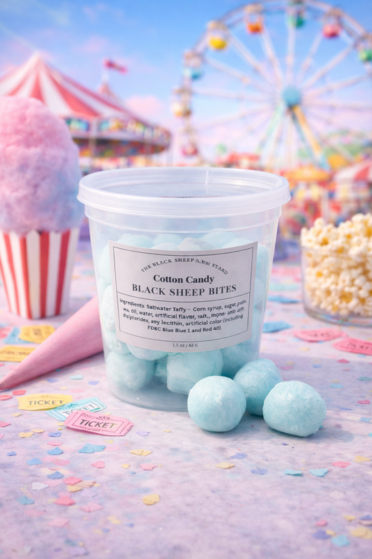 Container of freeze dried cotton candy saltwater taffy with a colorful fairground background including a Ferris wheel, carousel, cotton candy, and popcorn.